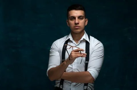 Confident young man posing on dark background Stock Photos