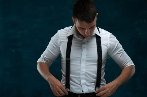 Confident young man posing on dark background Stock Photos
