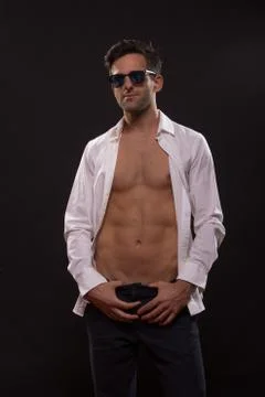 Confident young man posing unbuttoned shirt Stock Photos