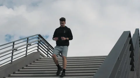 Confident young man running and going down the stairs. Sport lifestyle Stock Footage 272143406