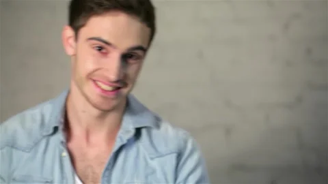 Confident young man showcasing a thoughtful expression Stock Footage 311522503