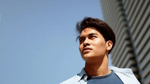 A Confident Young Man Using Mobile Phone in Urban City. Low Angle View. Slow Stock Footage 122722370