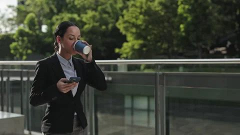 Confident Young Specialist Browsing In Internet and Drinking Coffee Outdoors Stock Footage 267182204