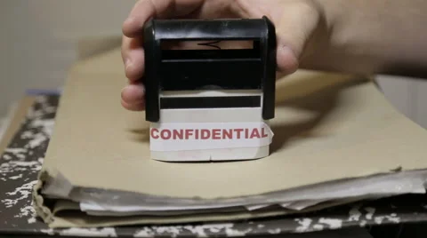 Confidential stamp on a big folder of paperwork Stock Footage 58480790