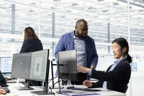 Configuring PCB electronic hardware setups, computer and man in tech laboratory Stock Photos