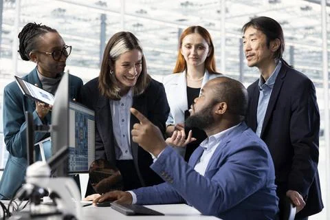 Configuring PCB electronic hardware setups, computer and multiethnic team Stock Photos