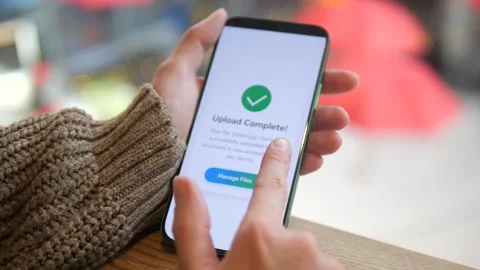 A confirmation message for successful file uploading on a mobile device in a Stock Footage 318947274