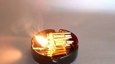 Conflagration of matches in a black ashtray Stock Footage 94953049