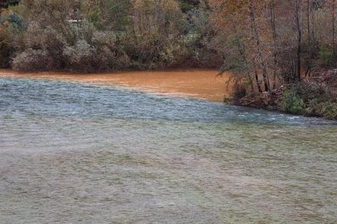 Confluence contrasting rivers Stock Photos