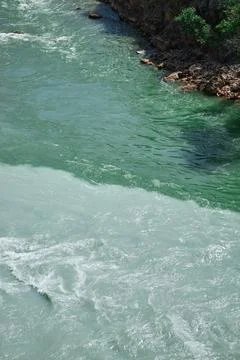 Confluence of two rivers of different colors Stock Photos