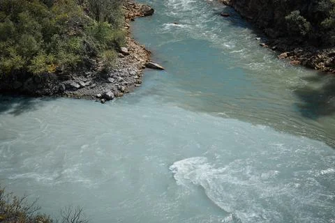 Confluence of two rivers of different colors Stock Photos