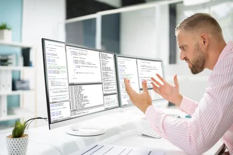Confused Angry Programmer Using Computer 스톡 사진