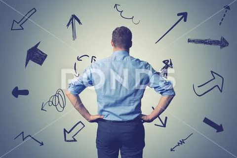 Confused businessman with direction arrows. choosing the right way decision c Stock Photos