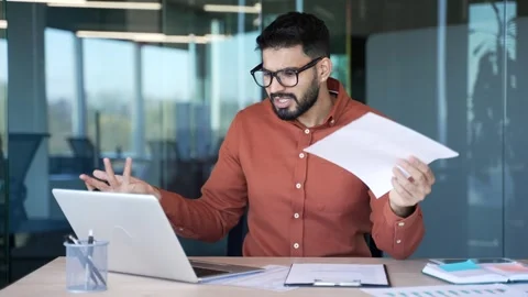 Confused businessman having difficulty with paperwork checking documents  Stock Footage 320616628