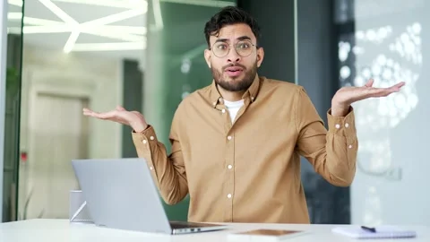 Confused businessman having difficulty using laptop sitting at workplace  Stock Footage 276424780