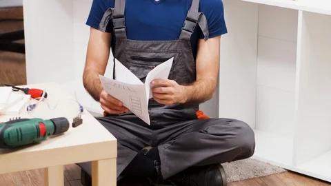 Confused contractor while checking instruction Stock Footage 123357882