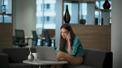 Confused developer explaining smartphone sofa closeup. Manager watching laptop 스톡 동영상 228506667