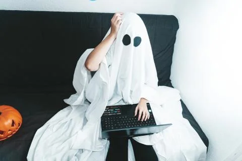 Confused ghost working on his computer on a halloween day Stock Photos