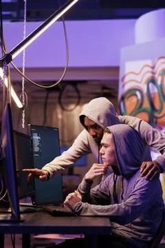 Confused hacker pointing at code mistake Stock Photos