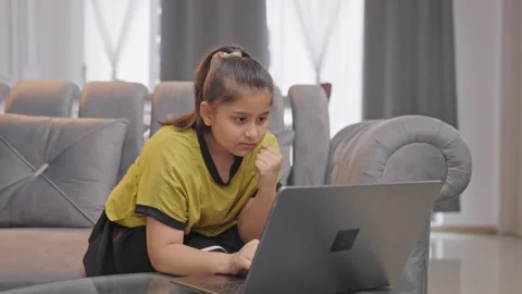 Confused Indian kid girl using Laptop | Stock Video | Pond5