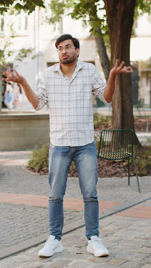 Confused Indian man feeling embarrassed about ambiguous question, having doubts Stock Footage 309239283