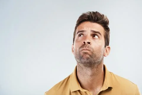 Confused, man and thinking in studio for solution, problem solving and unsure 写真素材