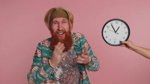 Confused man with anxiety checking time on clock, running late to work, being in Stock Footage 227649582