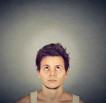 Confused man thinking looking up copy space above head Stock Photos