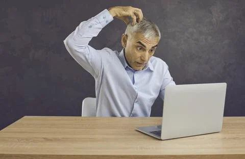 Confused man work on computer feel frustrated Stock Photos