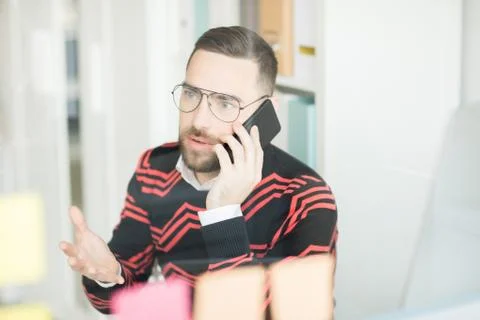 Confused manager solving problems on phone 写真素材