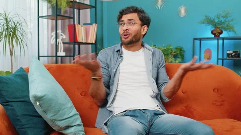 Confused middle eastern man feeling embarrassed about ambiguous question, having Stock Footage 282964193