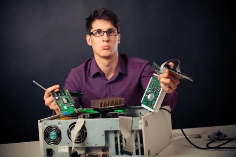 Confused Nerd With Lots Of Hardware Stock Photos