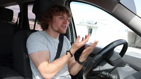 Confused nervous driver gestures while struggling to understand road situation Stock-Footage 343720245