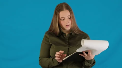 Confused office worker examines papers holding clipboard Stock-Footage 316099749