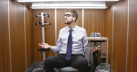 Confused office worker sitting and looking around Stock Footage 309000574