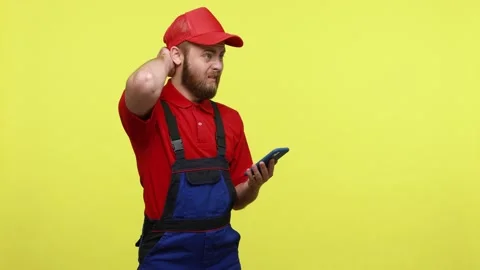 Confused pensive workman using smart phone, service application, system error, Stock Footage 161437173