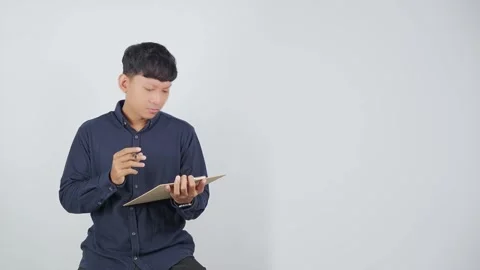 Confused Person Repeatedly Reading Document 動画素材 344830513