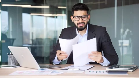 Confused puzzled businessman having difficulty with paperwork sitting  Stock Footage 318218627