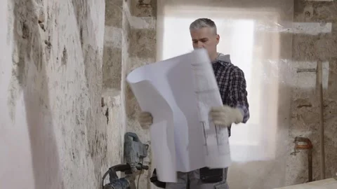 Confused puzzled construction builder worker at a renovation building site .. Stock Footage 307840673
