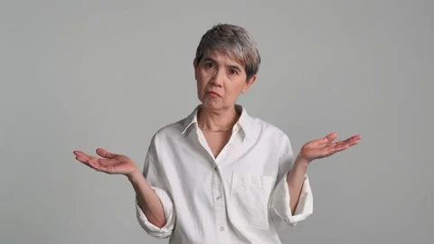 Confused puzzled upset middle aged Asian woman Stock Footage 159845328