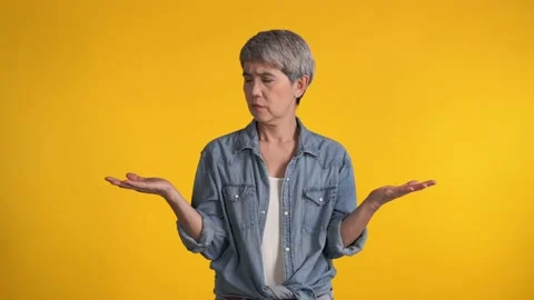 Confused puzzled upset middle aged Asian woman Stock Footage 159845759