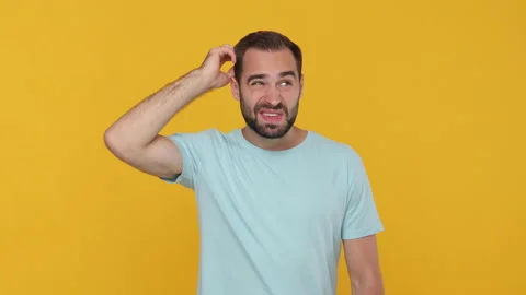 Confused thoughtful fun bearded young man 20s in basic casual blue t-shirt 스톡 동영상 148282966