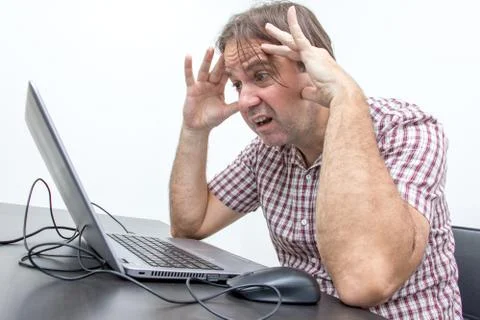The confused unhappy user is looking at the computer screen. Stock Photos