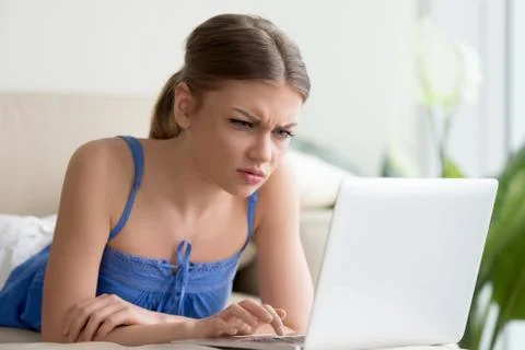 Confused woman having problem with computer, broken laptop, pc e Stock Photos
