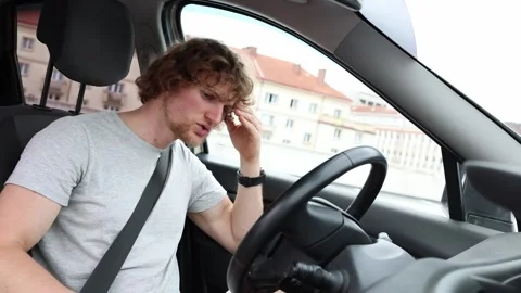 Confused young driver gets nervous when his car suddenly refuses to start Stock Footage 343720740