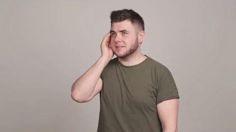 Confused young man thinking, scratching head, making desperate gestur Stock Footage 162366429