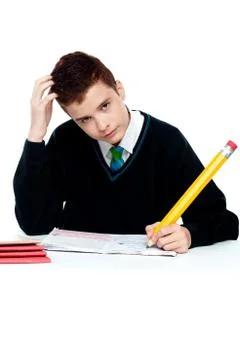 Confused young school boy thinking Stock Photos