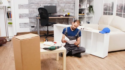 Confused young worker while reading instructions Stock Footage 123357154