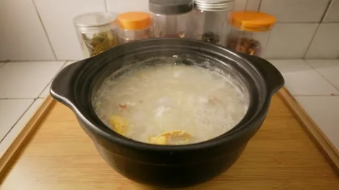 Congee cooked with Chinese yam, egg, lychee and rice is served on table. Stock Footage 342469692