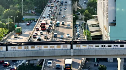 Congested highway and two MTR metro trains passing each other on the Stock-Footage 231199747